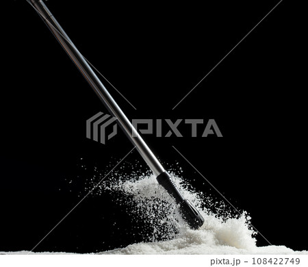 Trekking Poles put on snow ice. Telescopic trekking poles stick device for elderly people to walk with support protection hiking in woods mountain. Black background isolated 108422749