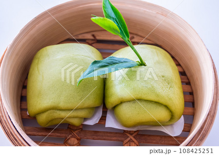 Steamed bun and green tea leaves isolated on white background. clipping path 108425251