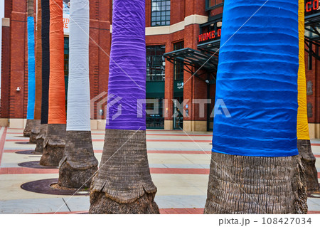 Rainbow wrapped palm tree trunks in front of Oracle Park entrance 108427034