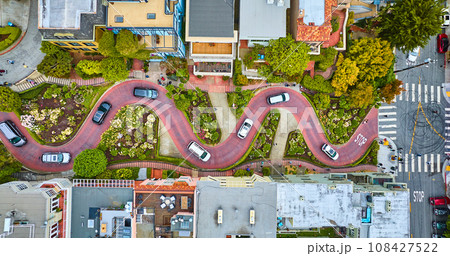 Straight down shot over Lombard Street with cars and road running horizontally through aerial Straight down shot over Lombard Street with cars and road running horizontally through aerial 108427522