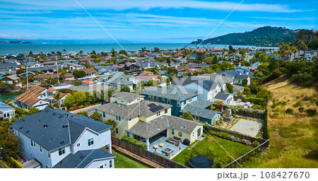 Low aerial over rich houses in Tiburon overlooking houses in Paradise Cay Yacht Harbor Low aerial over rich houses in Tiburon overlooking houses in Paradise Cay Yacht Harbor 108427670