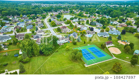 Suburban neighborhood with tennis court and playground aerial Suburban neighborhood with tennis court and playground aerial 108427897