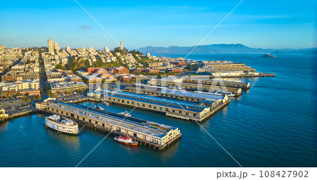 Sunrise aerial San Francisco piers with Coit Tower and Alcatraz Island in distance Sunrise aerial San Francisco piers with Coit Tower and Alcatraz Island in distance 108427902