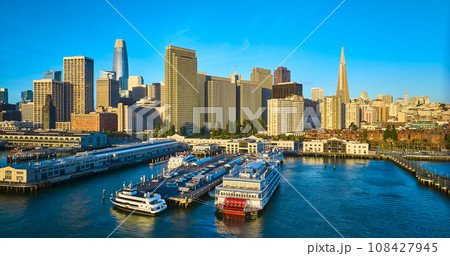 Aerial sunrise lighting over docked ships at Pier 7 with San Francisco skyscraper skyline Aerial sunrise lighting over docked ships at Pier 7 with San Francisco skyscraper skyline 108427945