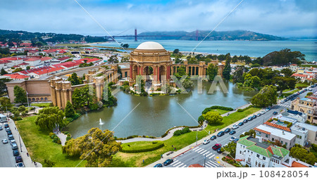 Aerial full view Palace of Fine Arts lagoon and colonnade pillars with Golden Gate Bridge Aerial full view Palace of Fine Arts lagoon and colonnade pillars with Golden Gate Bridge 108428054