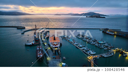 Beautiful sunset lighting over San Francisco Bay with Alcatraz and Hyde St Pier aerial Beautiful sunset lighting over San Francisco Bay with Alcatraz and Hyde St Pier aerial 108428546