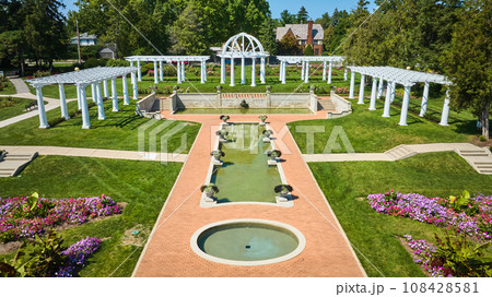 Aerial circular and rectangle pools of water leading to gorgeous outdoor wedding location at park 108428581