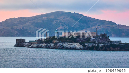 Alcatraz Island with pink glow over island and distant mountain aerial 108429046
