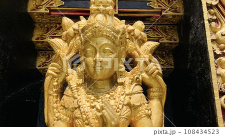 Balinese Hindu God golden Shiva Durga statue on a sacred Hindu temple in Indonesia Balinese Hindu God golden Shiva Durga statue on a sacred Hindu temple in Indonesia 108434523