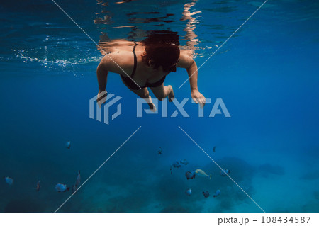 60s woman snorkeling in blue ocean. Snorkeling at vacation in Hawaii 60s woman snorkeling in blue ocean. Snorkeling at vacation in Hawaii 108434587