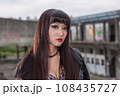 Asian woman in emo goth clothes at an abandoned building 108435727
