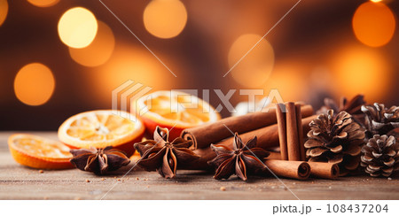 Traditional Christmas spices and dried orange slices on holiday bokeh background with defocus lights 108437204