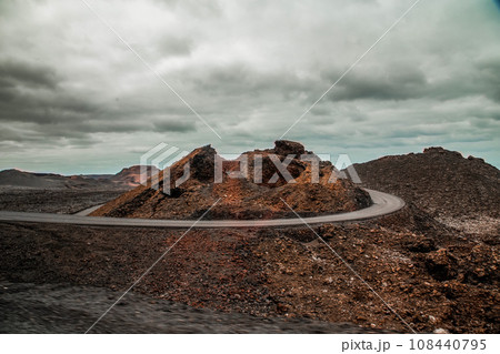 Amazing panoramic landscape of volcano in Timanfaya national park. Popular touristic in Lanzarote island Canary islans Spain. Artistic picture. Travel concept Amazing panoramic landscape of volcano in Timanfaya national park. Popular touristic in Lanzarote island Canary islans Spain. Artistic picture. Travel concept 108440795