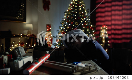 little boy sleeping on his desk in Christmas 108444008