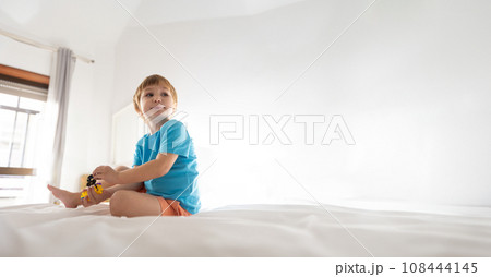 Photo of a Curious Child Contemplating the World From His Bed - copy space Photo of a Curious Child Contemplating the World From His Bed - copy space 108444145