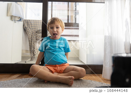 Photo of a Playful Toddler Expressing His Amusement with a Comical Facial Expression 108444148