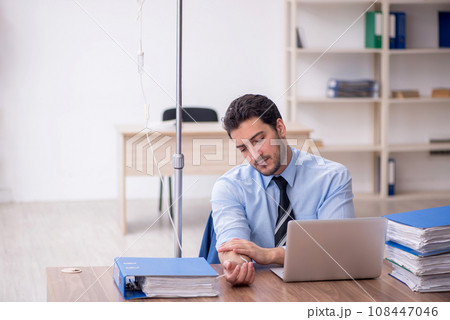 Young male employee suffering at workplace 108447046
