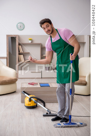 Young male contractor cleaning the house 108448422