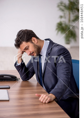 Young male employee working in the office 108448451