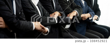 Business team sitting in line together symbolize business partnership. Shrewd Business team sitting in line together symbolize business partnership. Shrewd 108452921