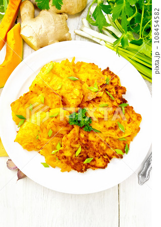 Pancakes of pumpkin with cheese in white plate on board top Pancakes of pumpkin with cheese in white plate on board top 108454582