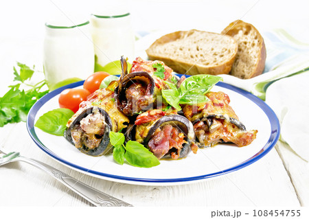 Rolls of eggplant with meat in plate on board 108454755