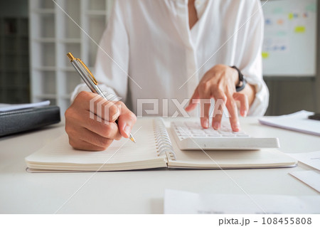 Asian business analyze the situation use a calculator on the financial report in the work room. Investment Consultant, Financial Consultant, Financial advisor and accounting concept 108455808