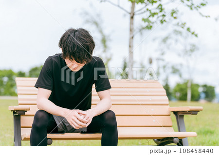 運動中に公園のベンチで休憩するアジア人男性（筋疲労・筋肉痛・オーバートレーニング症候群） 108458440