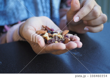 close up of many mixed nuts on hand close up of many mixed nuts on hand 108460354