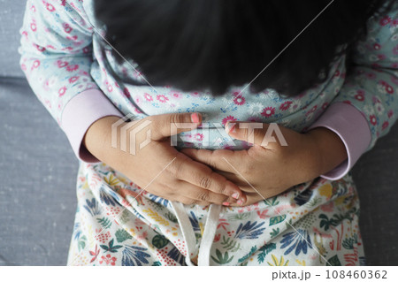 child suffering stomach pain close up. child suffering stomach pain close up. 108460362