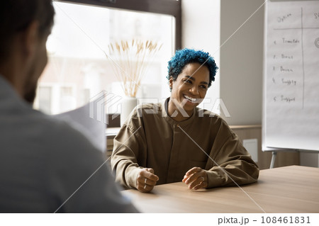 Happy pretty young African candidate laughing at successful job interview 108461831