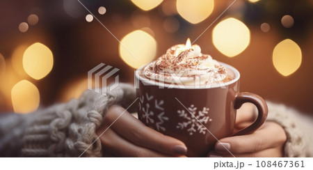 Hands holding a cup of Hot Chocolate in a fabulous Christmas atmosphere, decorated and bokehed,. 108467361