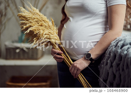Beautiful pregnant woman hugging her belly. Expectant mother waiting for baby birth during pregnancy 108468900