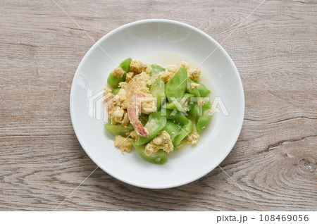 stir fried ridge gourd with egg stuffed shrimp in soy sauce on plate 108469056