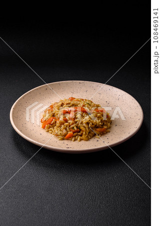 Delicious Uzbek pilaf with chicken, carrots, barberry, spices and herbs 108469141