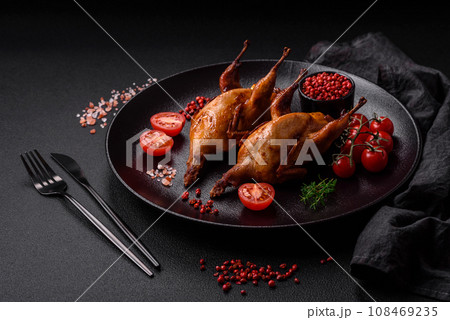 Roasted quail, partridge or pigeon stuffed with orange with spices and herbs Roasted quail, partridge or pigeon stuffed with orange with spices and herbs 108469235