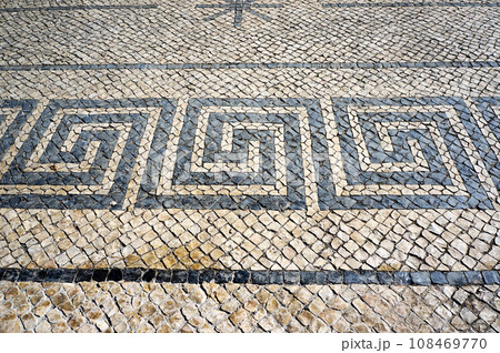Greek Meander Motif in Traditional Mosaic Paving Tiles on a Street of Lisbon, Portugal. Greek Meander Motif in Traditional Mosaic Paving Tiles on a Street of Lisbon, Portugal. 108469770