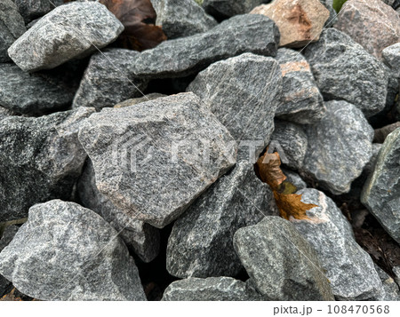Grey crushed stones in close up. Building material for horticulture, landscape gardening or road Grey crushed stones in close up. Building material for horticulture, landscape gardening or road 108470568