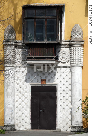 Kiev, Ukraine April 27, 2021: Facade of the entrance to an ancient building decorated with architectural elements of decor Kiev, Ukraine April 27, 2021: Facade of the entrance to an ancient building decorated with architectural elements of decor 108471171