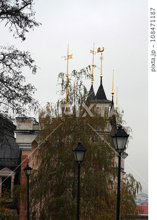 Kiev, Ukraine November 28, 2020: Architectural decoration of the building of the puppet theater with golden spiers with weather vane in the city of Kiev Kiev, Ukraine November 28, 2020: Architectural decoration of the building of the puppet theater with golden spiers with weather vane in the city of Kiev 108471187