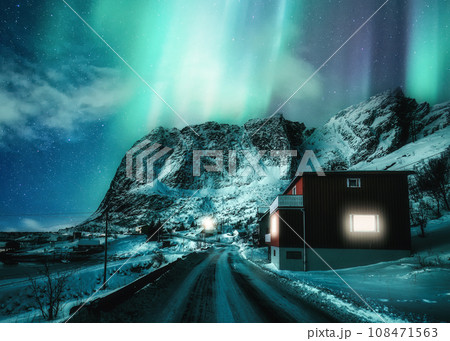Scenery of Aurora borealis or Northern lights dancing over snowy mountain in scandinavian village on winter at Lofoten Islands Scenery of Aurora borealis or Northern lights dancing over snowy mountain in scandinavian village on winter at Lofoten Islands 108471563