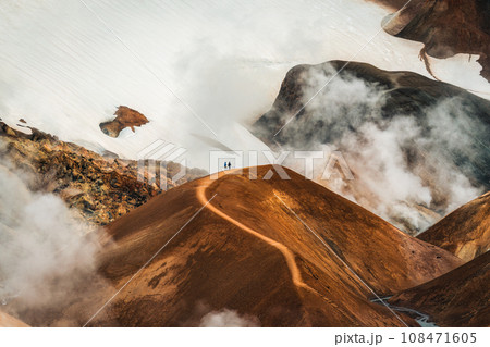 Landscape of Kerlingarfjoll volcanic mountain range with sulfur smoke and tourist hiking in summer at Icelandic Highlands 108471605