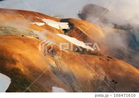 Kerlingarfjoll volcanic mountain range on geothermal area and sulphur smoke in summer at Highlands of Iceland Kerlingarfjoll volcanic mountain range on geothermal area and sulphur smoke in summer at Highlands of Iceland 108471610