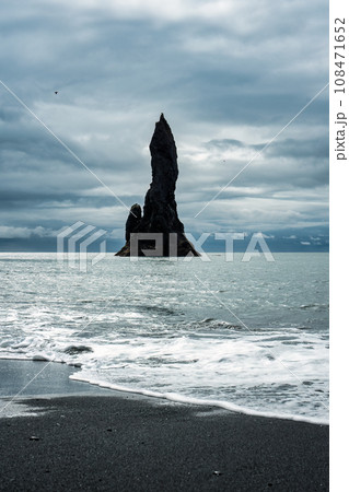 Moody Reynisdragar natural rock formation on Reynisfjara black sand beach in Atlantic ocean at Iceland Moody Reynisdragar natural rock formation on Reynisfjara black sand beach in Atlantic ocean at Iceland 108471652
