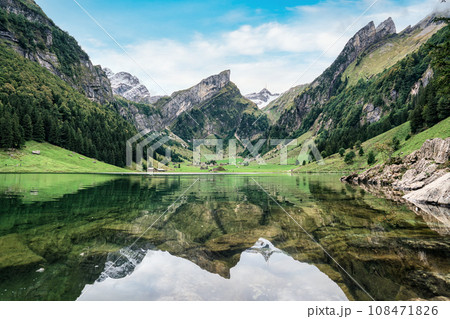 Seealpsee mountain lake reflection in Alpstein mountain range during summer at Appenzell, Switzerland 108471826