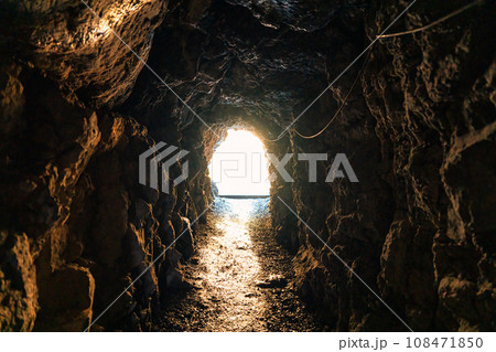 Natural cave mining underground tunnel rock and golden light at the destination 108471850