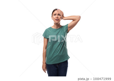 young forgetful brunette woman dressed in a green t-shirt on a white background 108471999