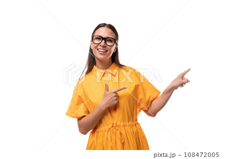 young well-groomed woman with black straight hair dressed in a yellow dress shows the news by 108472005