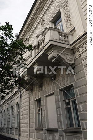 Kiev, Ukraine May 16, 2021: Facade of an old building with a balcony in the center of Kiev Kiev, Ukraine May 16, 2021: Facade of an old building with a balcony in the center of Kiev 108472043