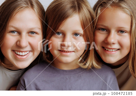 Faces of three girls in a row in casual clothes Faces of three girls in a row in casual clothes 108472185